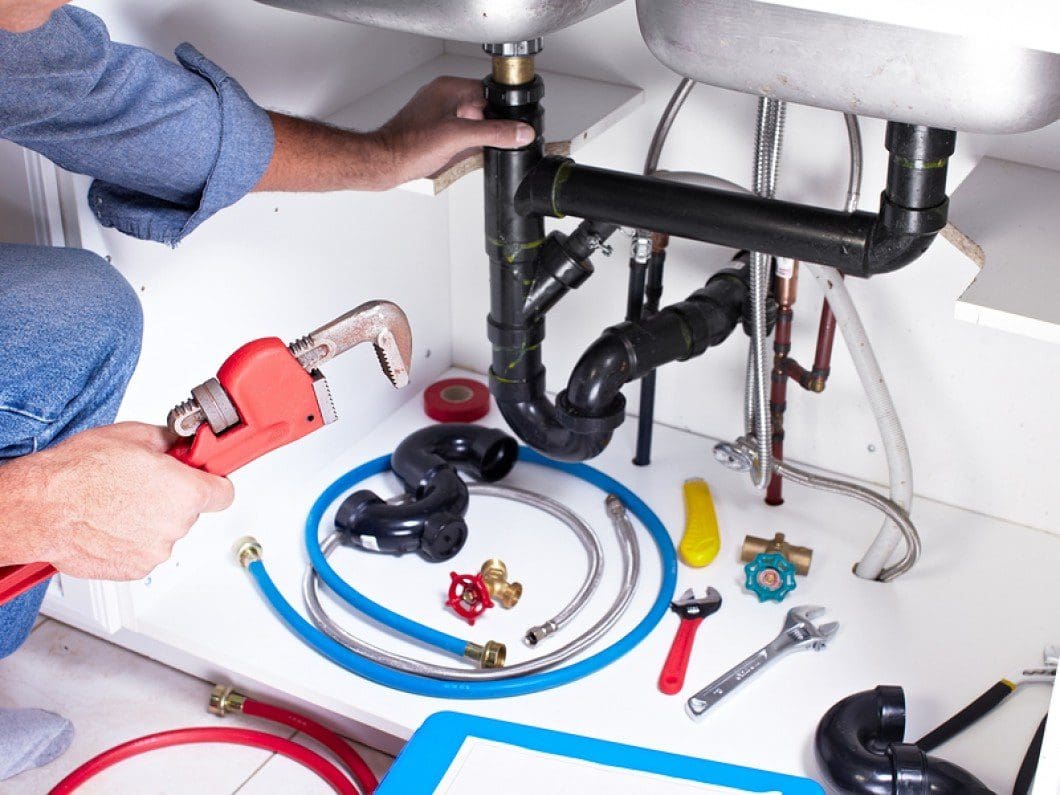 pro rec plumbing plumber hands with a wrench plumbers near me